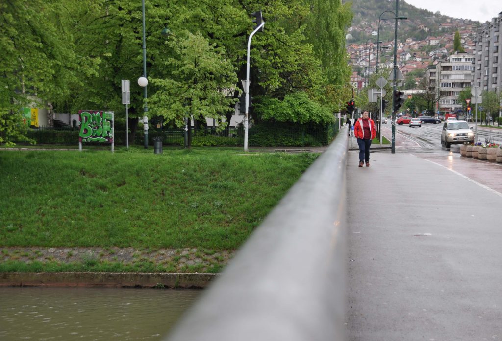 Lejla Kalamujić on the bridge she crossed during the war in Sarajevo