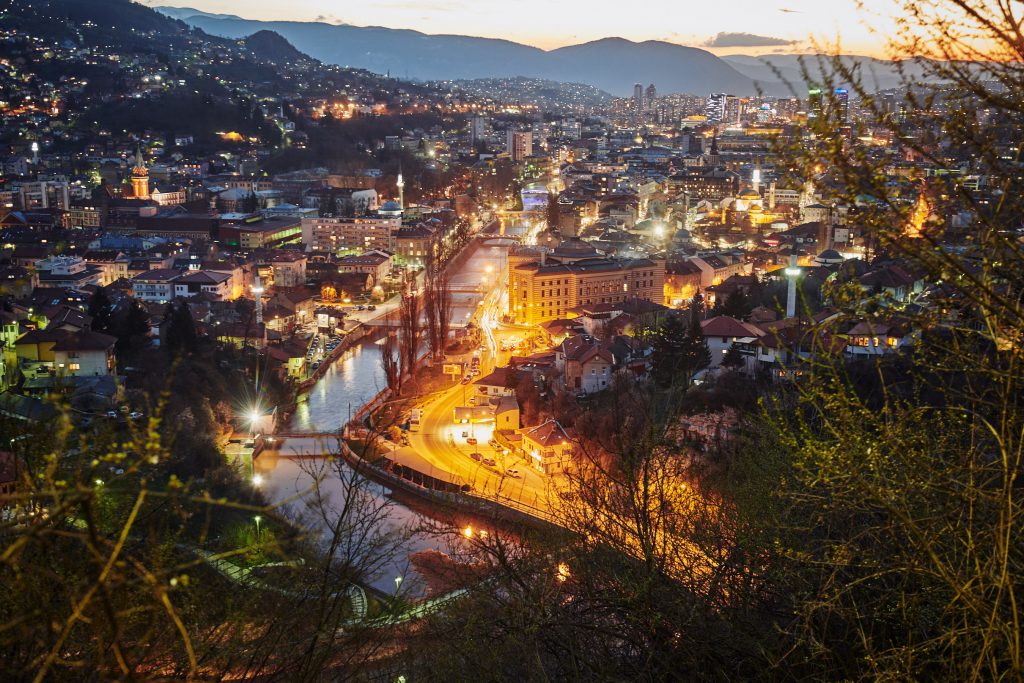 Vijećnica (City Hall) and Miljacka river floating through the night of Sarajevo